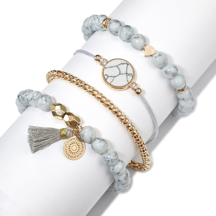 Pulsera de cuatro piezas geométrica creativa con flecos de piedra de pino